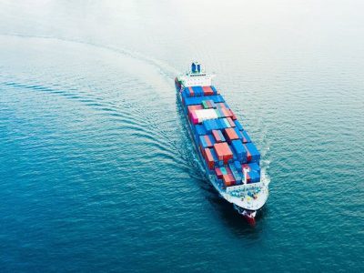 Aerial view Cargo container ship_ Business logistic transportation in the ocean ship carrying container,Cargo ship, Cargo container in factory harbor for import-export, Space for copy